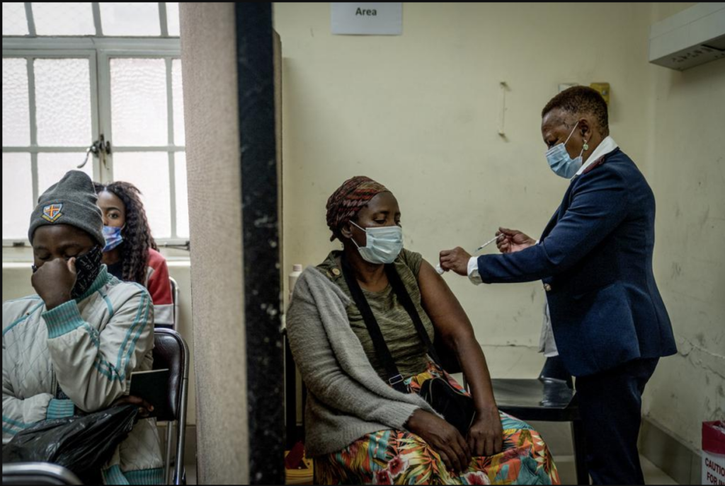 Screen Shot 2021-12-06 at 8.29.10 PM A woman is vaccinated against COVID-19 at the Hillbrow Clinic in Johannesburg, South Africa, Monday Dec. 6, 2021. South African doctors say the rapid increase in COVID-19 cases attributed to the new omicron variant is resulting in mostly mild symptoms. (AP Photo/ Shiraaz Mohamed)