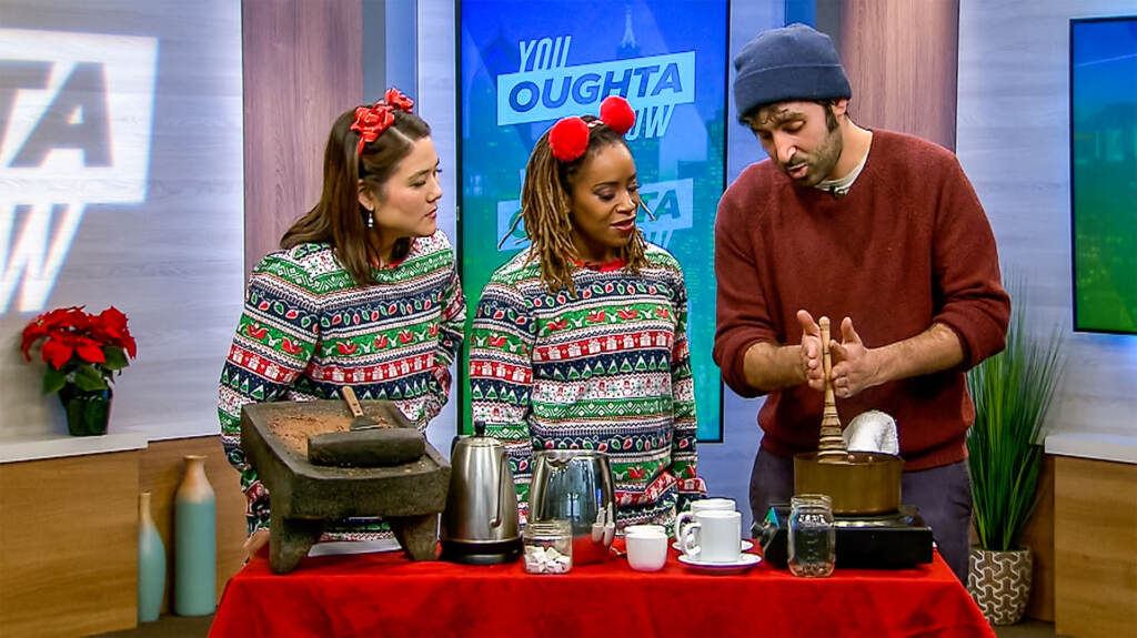 Shirley and Regina wearing Christmas pajamas making hot chocolate with someone from Shane Confectionery