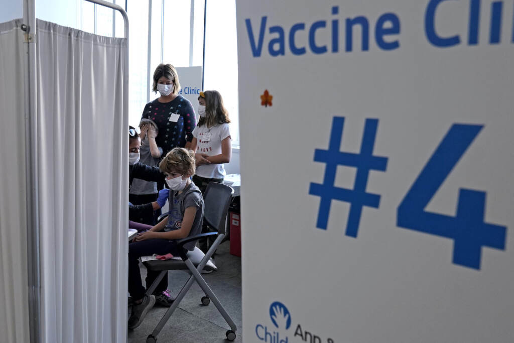 Graham Roark receives the Pfizer COVID-19 vaccine for children from Lurie Children's hospital registered nurse Virginia Scheffler