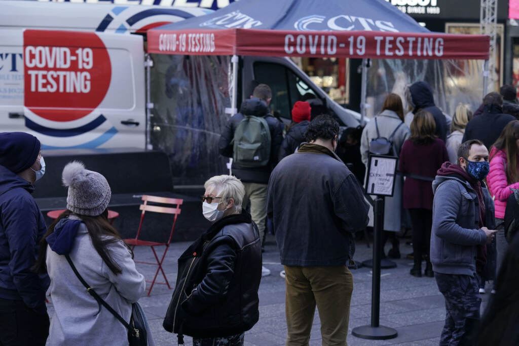 Virus Outbreak People wait in line at a COVID-19 testing site in Times Square