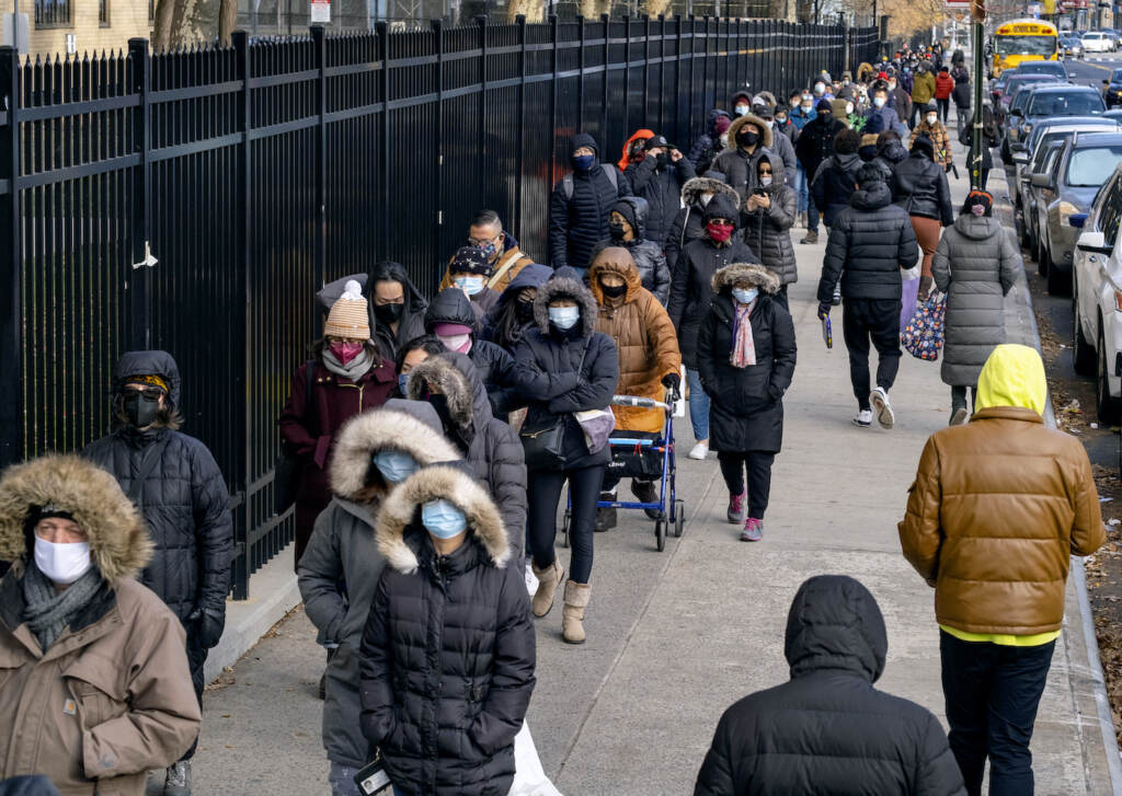 Virus Outbreak New York People line up to receive COVID-19 test kits in New York