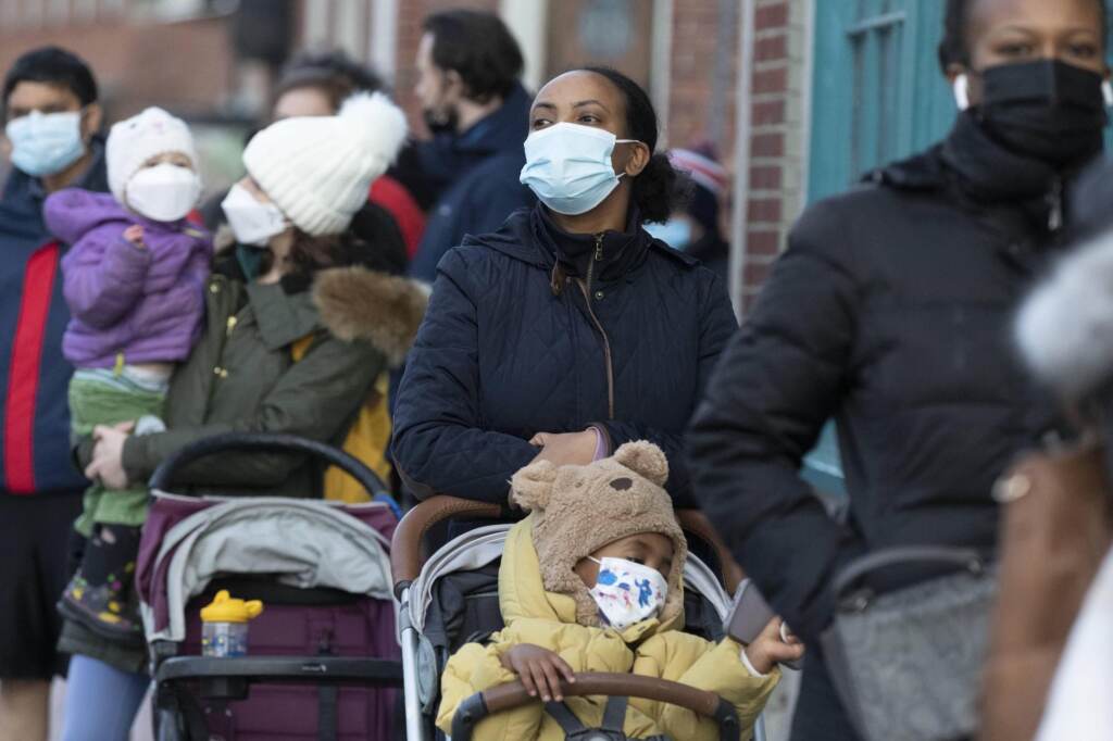 Virus Outbreak Makda Yesuf (center) and her son Jaden wait in line at a COVID-19 walk-in testing site