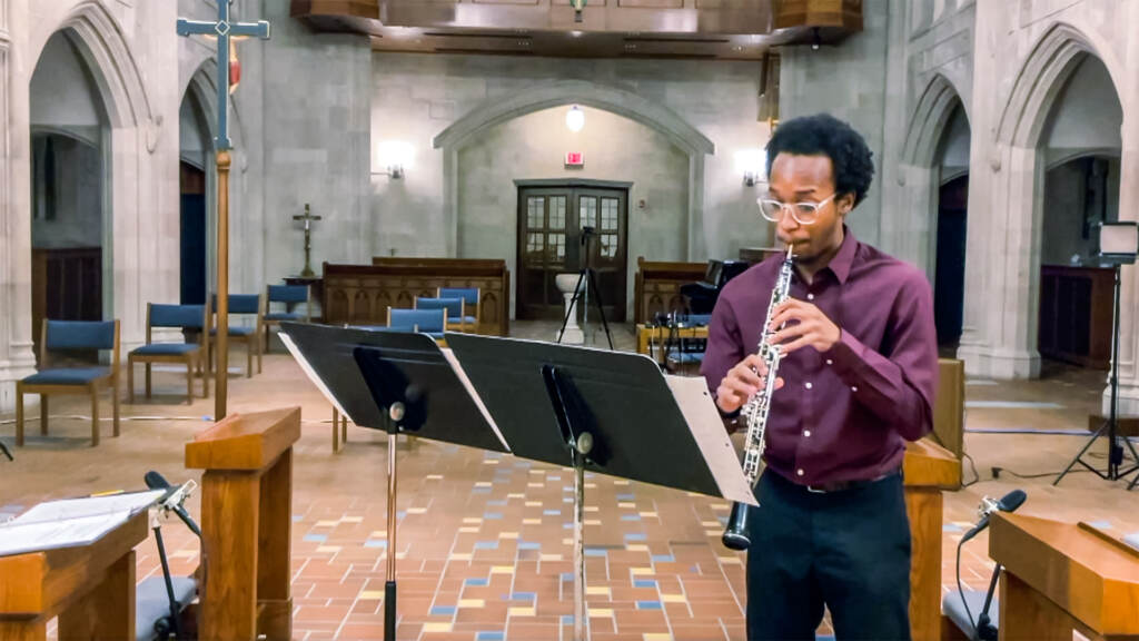 Mekhi Gladden playing the oboe in a church