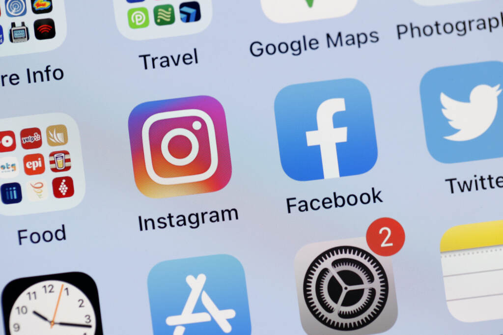 The Facebook and Instagram apps are seen on the screen of an iPhone