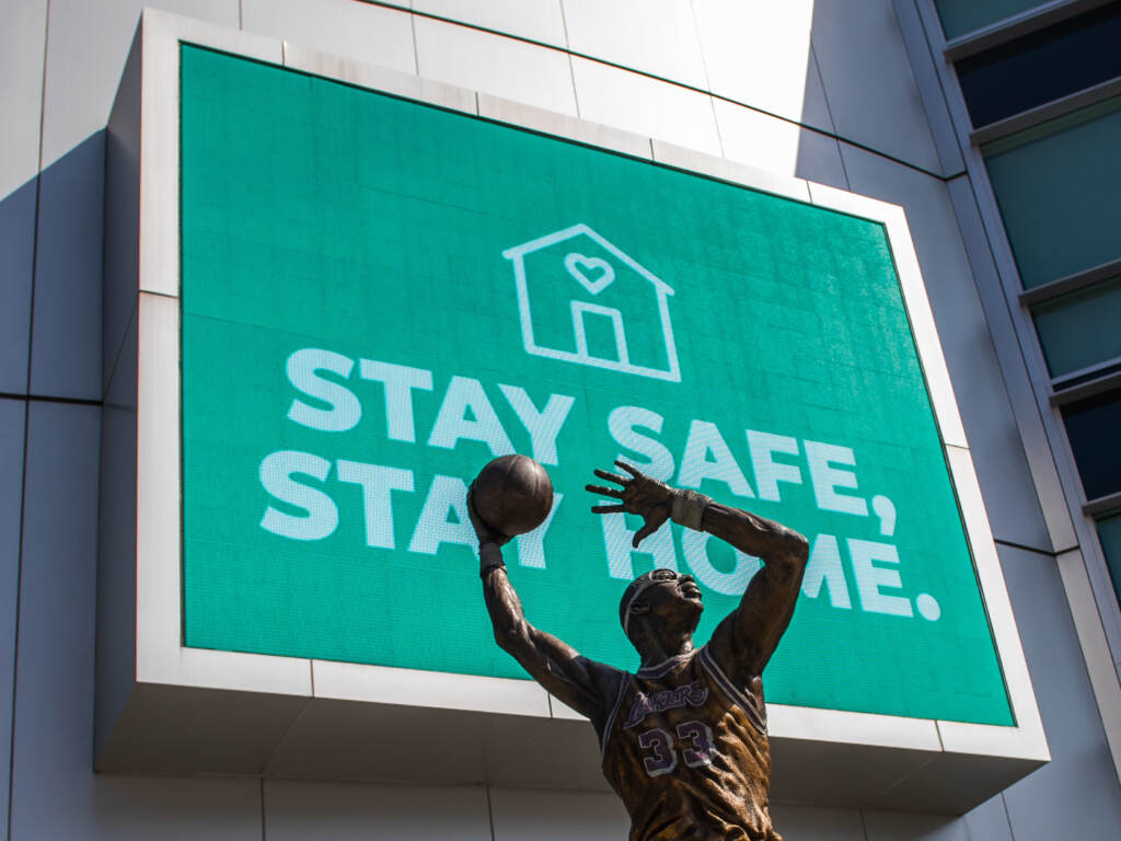 Do we still need to “stay home” to stay safe? The Staples Center is seen in downtown Los Angeles with a sign that reads,