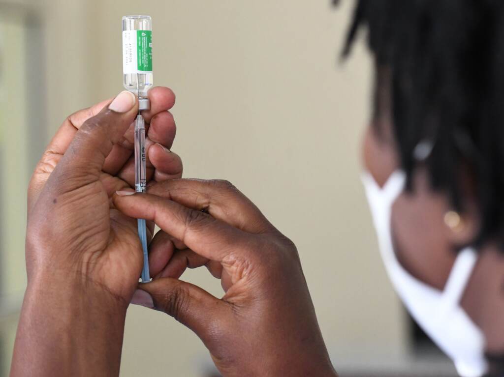 Despite global pledges on vaccine supply, only 7% of Africa’s population is vaccinated. A Kenyan health worker prepares to administer a dose of the Oxford/AstraZeneca vaccine