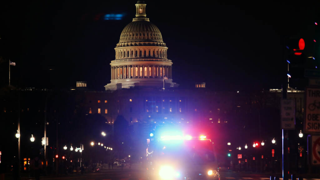 A police car drives away from the U.S. Capitol on Jan. 6, 2021. A police car drives away from the Capital after thousands of Donald Trump supporters stormed the United States Capitol building following a