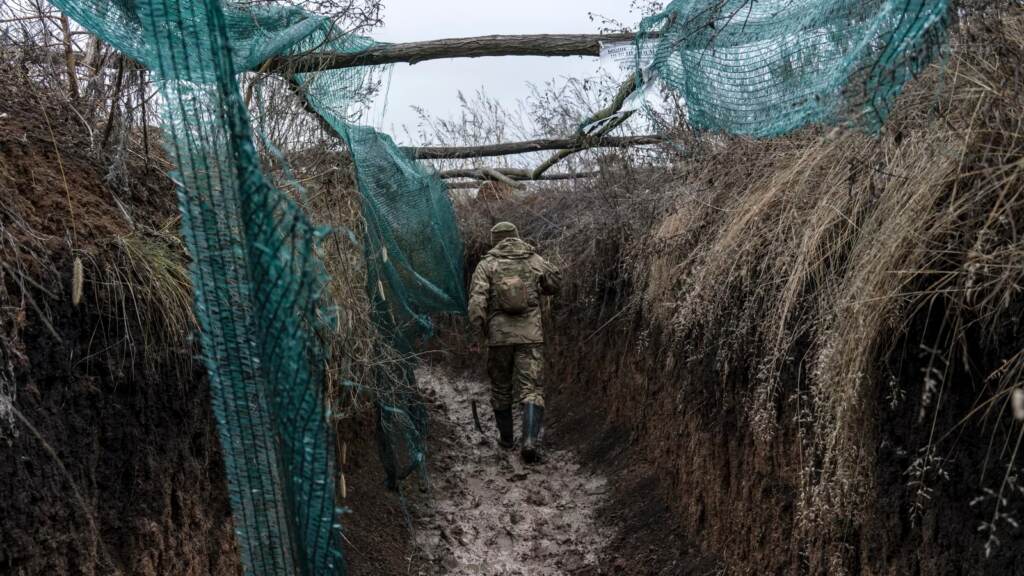 A Ukrainian soldier walks in a trench on the front line in Zolote, Ukraine, earlier this month. A buildup of Russian troops along the border with Ukraine has heightened worries that Russia intends to invade. A Ukrainian soldier, who goes by the nickname Chorny, walks in a trench on the front line on December 12, 2021 in Zolote, Ukraine. (Brendan Hoffman/Getty Images)