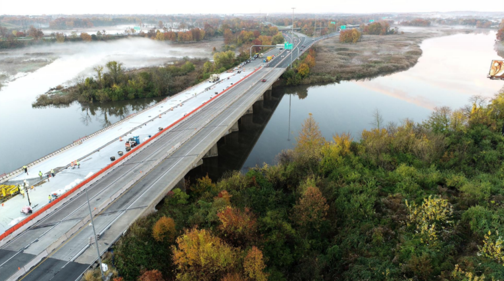 image Aerial view of I-95, including the river beneath it and trees on the sides of the highway.