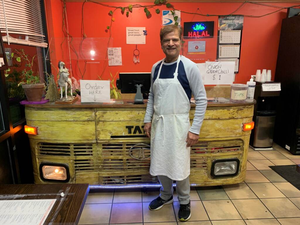 Jagdeep Nayyar, owner and chef at My Taste of India, stands in front of the register stand that’s made from the front panel of a real Tata truck — the best-selling brand in India. Jagdeep Nayyar, owner and chef at My Taste of India, stands in front of the register stand that's made from the front panel of a real Tata truck — the best-selling brand in India. (Joel Rose/Joel Rose)