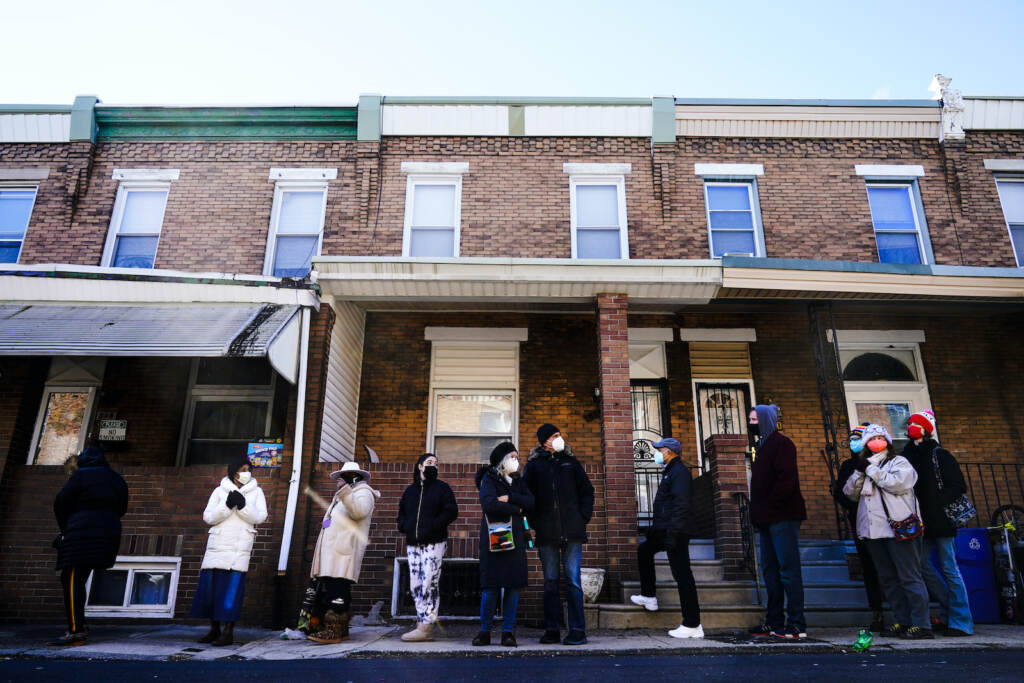 Virus Outbreak Pennsylvania City residents wait in a line extending around the block to receive free at-home rapid COVID-19 test kits in Philadelphia