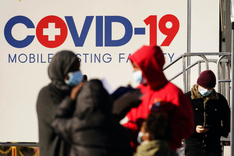 People wait at a COVID-19 mobile testing site