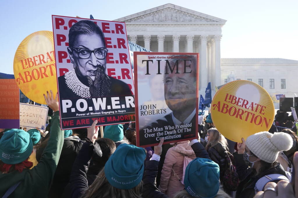 People demonstrate in front of the U.S. Supreme Court