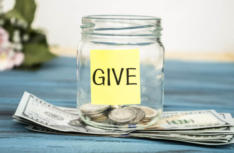 Coins in a glass jar with the word 