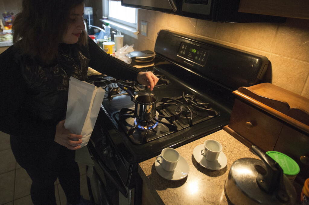 Recent refugee from Syria Sandy Khabbazeh makes a pot of Syrian coffee on a stove in Oakland, New Jersey Sandy Khabbazeh makes a pot of Syrian coffee