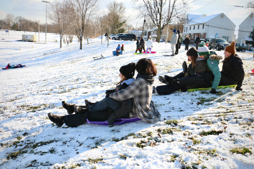 Children sled on a slope in Williamson Park in Morrisville. (Emma Lee/WHYY) Children sled on a slope in Williamson Park in Morrisville. (Emma Lee/WHYY)