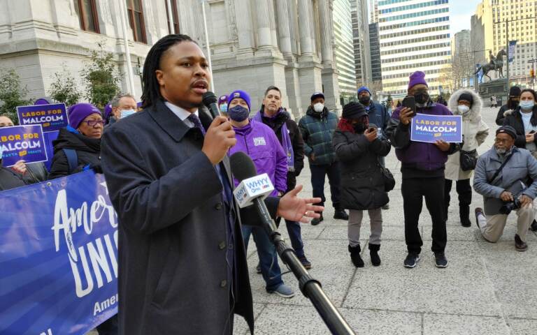 Rep. Malcolm Kenyatta stands with members of SEIU outside City Hall in Philadelphia on Jan. 19, 2022. (Tom MacDonald/WHYY)