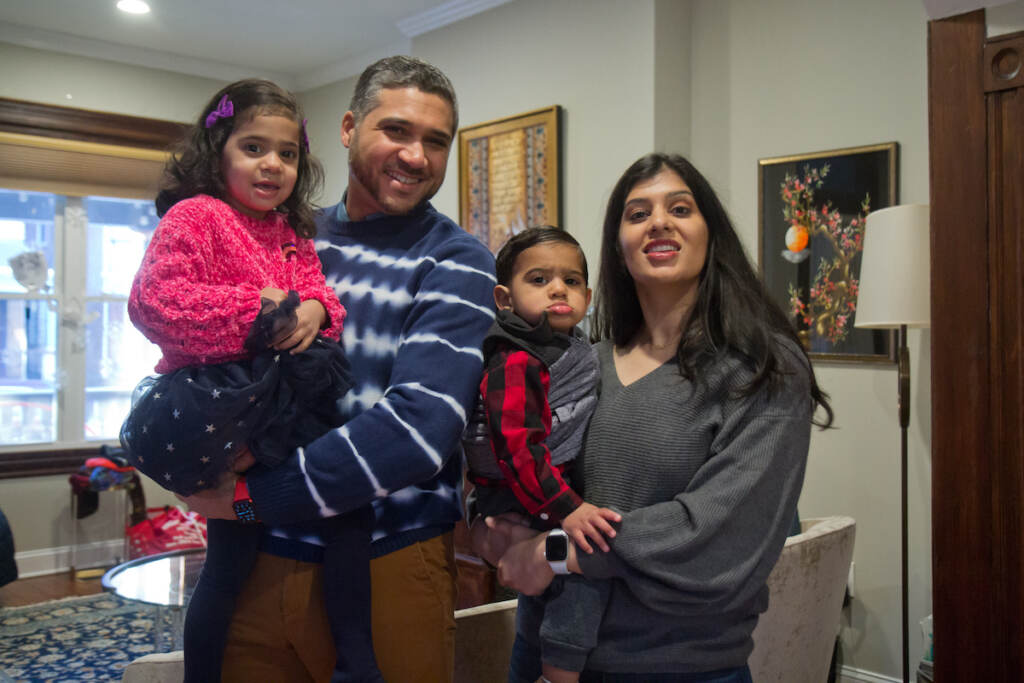 Salma Khan with her son Zayd, 22 months old, husband Bilal, and daughter Aziza, 3, at their home in West Philadelphia on Jan. 27, 2022. (Kimberly Paynter/WHYY)