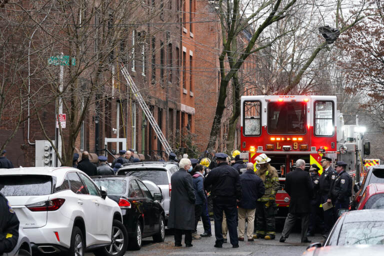 Philadelphia firefighters work at the scene of a deadly fire
