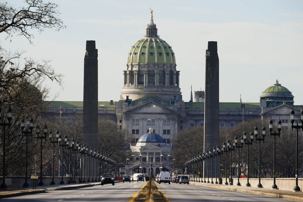 Pennsylvania Capitol The Pennsylvania Capitol building in Harrisburg is shown from afar, with the road stretching towards it.