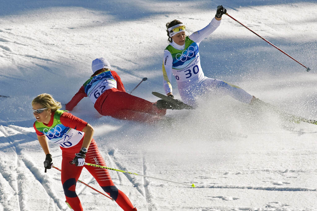OLY XXC Climate Dangerous Snow FILE - Norway's Vibeke Skofterud, left, escapes a crash involving Sweden's Norgren Johansson, right, and Poland's Paulina Maciuszek in the women's 15-kilometer pursuit cross country skiing event at Whistler Olympic Park on February 19, 2010, at the 2010 Vancouver Olympic Winter Games in Whistler, B.C. Many top Nordic skiers and biathletes say crashes are becoming more common as climate change reduces the availability of natural snow, forcing racers to compete on tracks with the manmade version. (AP Photo/Andrew Vaughan, CP, File)