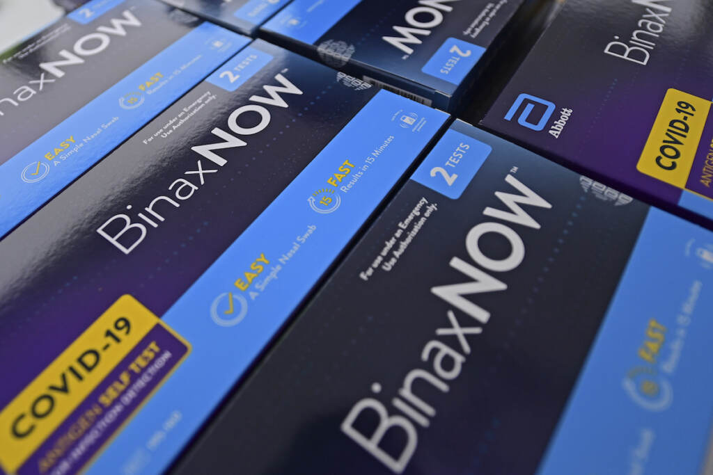 Virus Outbreak Ohio At-home COVID-19 tests kits sit on a table before being handed out at a distribution site, Thursday, Dec. 30, 2021, in Youngstown, Ohio. (AP Photo/David Dermer)