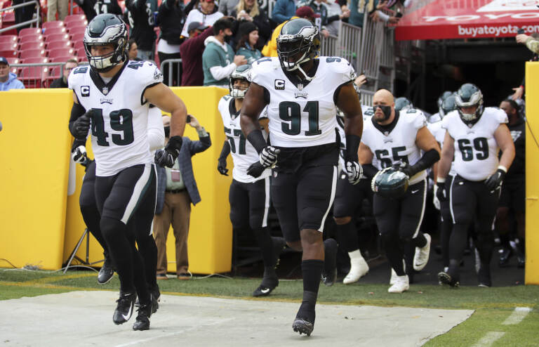 Philadelphia Eagles defensive tackle Fletcher Cox (91) leads out his team before a game against the Washington Football Team, Sunday, Jan. 02, 2022 in Landover. (AP Photo/Daniel Kucin Jr.)