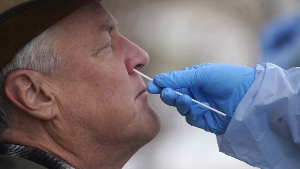 Virus Outbreak Utah A member of the Salt Lake County Health Department COVID-19 testing staff performs a test on Gary Mackelprang outside the Salt Lake County Health Department Tuesday, Jan. 4, 2022, in Salt Lake City