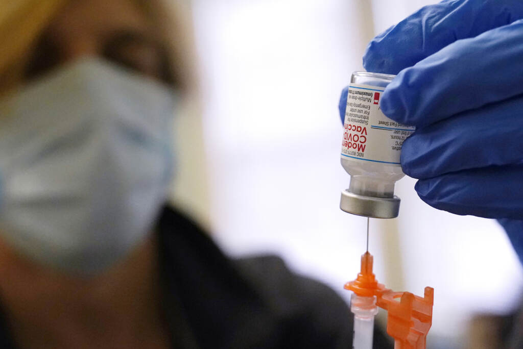 Virus Outbreak-Moderna-Booster Pharmacist Kenni Clark prepares a booster dose of the Moderna COVID-19 vaccine during a vaccination clinic at City of Lawrence's
