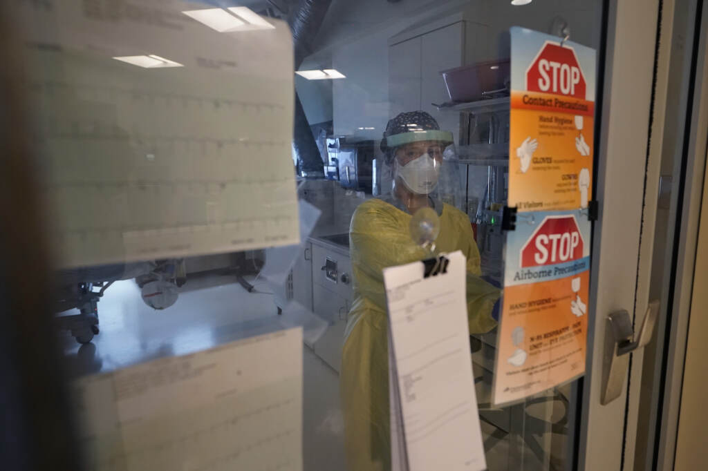 Registered nurse Morgan Flynn works inside a patient's room