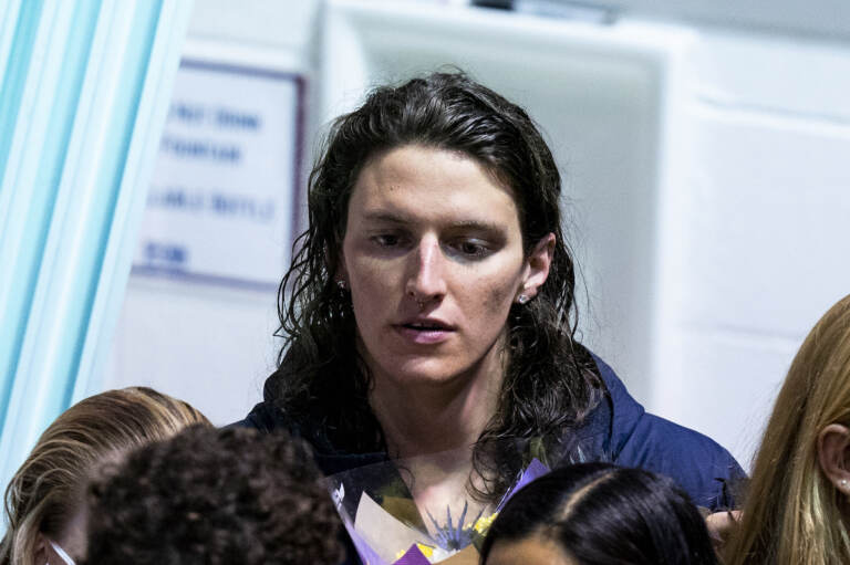 Pennsylvania's Lia Thomas looks on as she celebrates senior day with her teammates during a swim meet, Saturday, Jan. 8, 2022, in Philadelphia. The NCAA has adopted a sport-by-sport approach for transgender athletes, bringing the organization in line with the U.S. and International Olympic Committees. NCAA rules on transgender athletes returned to the forefront when Penn swimmer Lia Thomas started smashing records this year