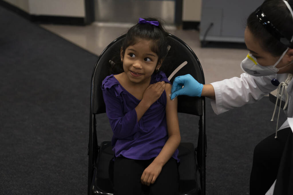 Virus Outbreak File photo: Elsa Estrada, 6, smiles at her mother as pharmacist Sylvia Uong applies an alcohol swab to her arm before administering the Pfizer COVID-19 vaccine at a pediatric vaccine clinic for children ages 5 to 11 set up at Willard Intermediate School in Santa Ana, Calif., Nov. 9, 2021. (AP Photo/Jae C. Hong, File)