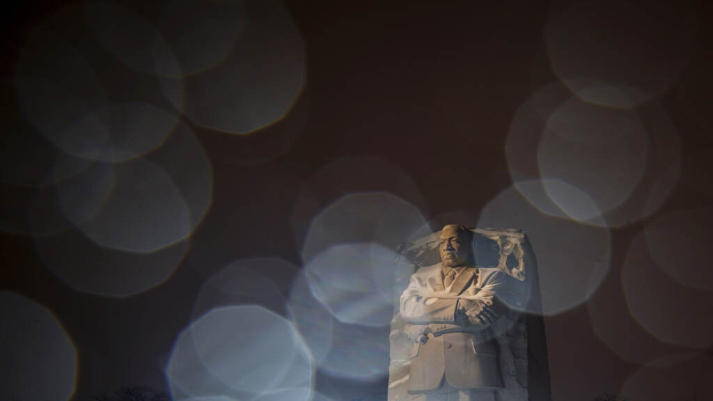 APTOPIX Winter Weather Washington In a long exposure photo, lights from a snowplow illuminate sleet at the Martin Luther King Jr. Memorial in Washington, Sunday, Jan. 16, 2022. Ceremonies scheduled for the site on Monday, to mark the Martin Luther King Jr. national holiday, have been canceled because of the weather. (AP Photo/Carolyn Kaster)