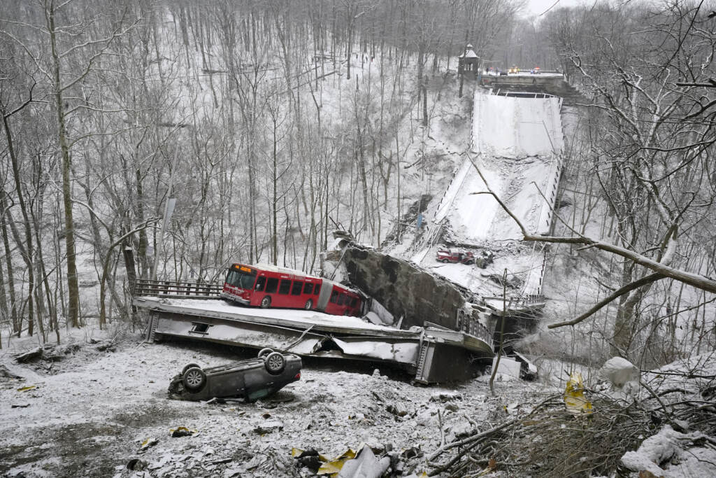 APTOPIX Bridge Collapse Pittsburgh A Port Authority bus that was on a bridge when it collapsed Friday Jan. 28, 2002, is visible in Pittsburgh’s East End. When the bridge collapsed, rescuers rappeled nearly 150 feet while others formed a human chain to help rescue multiple people from the dangling bus. (AP Photo/Gene J. Puskar)