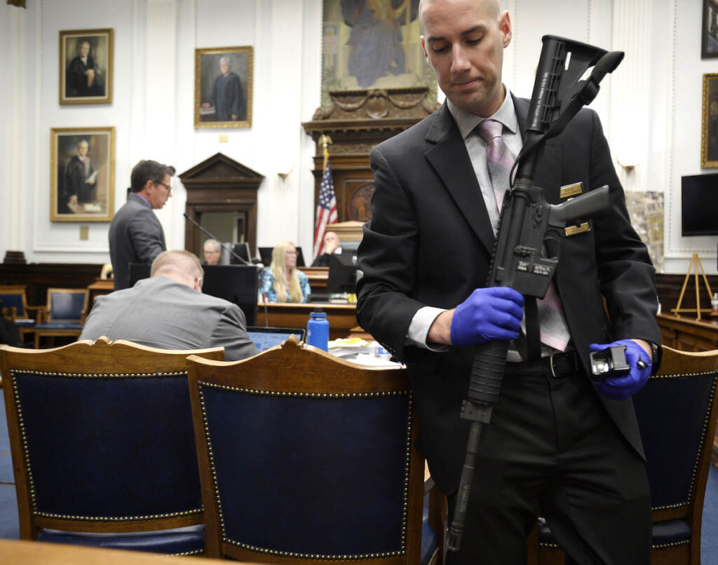 Kenosha Protest Shootings File photo: Kenosha Police Department Detective Martin Howard, right, picks up the weapon Kyle Rittenhouse used on Aug. 25, 2020, during Rittenhouse's trial at the Kenosha County Courthouse in Kenosha, Wis., on Nov. 8, 2021. A Wisconsin judge on Friday, Jan. 28, 2022, approved an agreement by lawyers to destroy the assault-style rifle that Rittenhouse used to shoot three people during a 2020 street protest