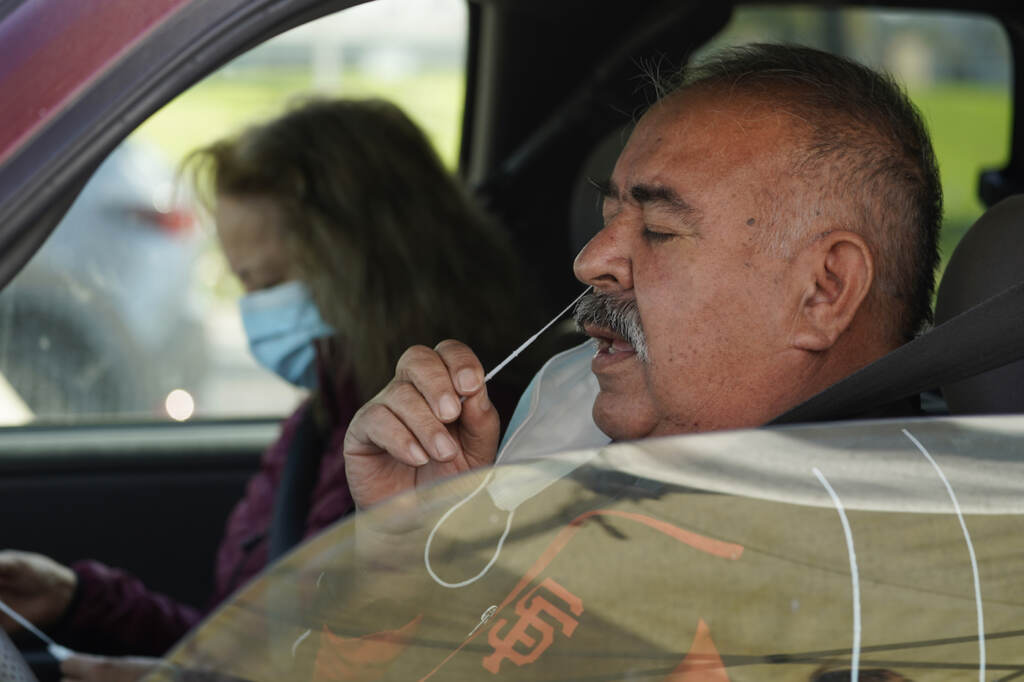 Jose Alfrtedo De la Cruz, Rogelia De la Cruz Jose Alfrtedo De la Cruz and his wife, Rogelia, self-test for COVID-19 at a No Cost COVID-19 Drive-Through event provided the GUARDaHEART Foundation for the City of Whittier community and the surrounding areas at the Guirado Park in Whittier, Calif., on Tuesday, Jan. 25, 2022. California is showing signs that it may have turned the corner on the latest omicron wave of the coronavirus pandemic, with cases falling and hospitalizations short of the overwhelming deluge that officials had predicted just weeks ago. (AP Photo/Damian Dovarganes)