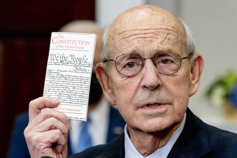 Supreme Court Associate Justice Stephen Breyer holds up a copy of the United States Constitution as he announces his retirement in the Roosevelt Room of the White House in Washington, Thursday, Jan. 27, 2022. (AP Photo/Andrew Harnik)