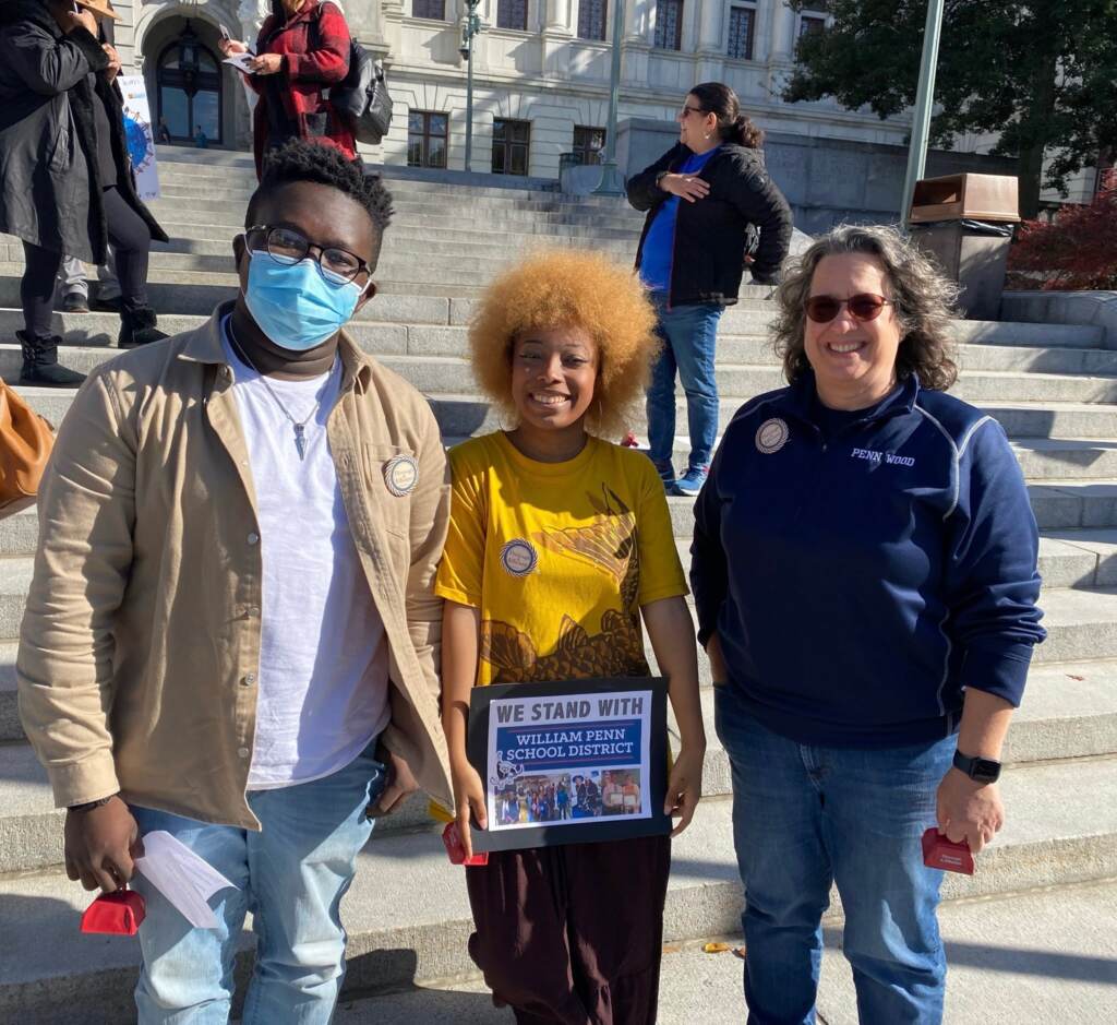 Paul Vandy (L) and Trinity Giddings (C) stand alongside William Penn school board member Jennifer Hoff (R)in Harrisburg on Nov. 12 (From left) Paul Vandy and Trinity Giddings stand alongside William Penn school board member Jennifer Hoff in Harrisburg on Nov. 12. (Courtesy of Tomea Sippio-Smith)