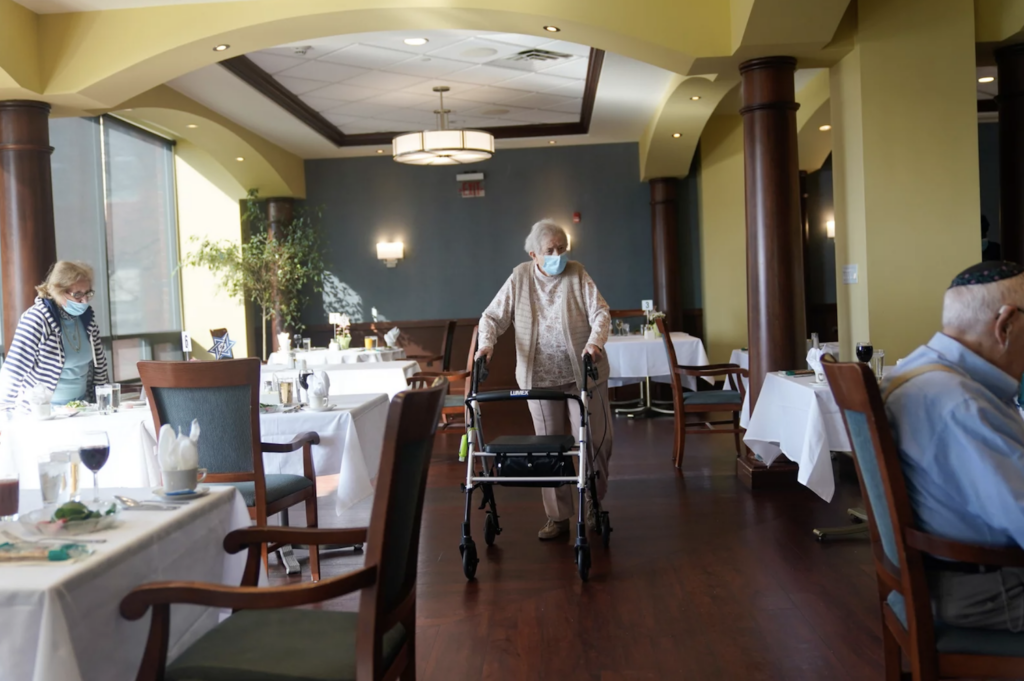 May Nast arrives for dinner at RiverWalk, an independent senior housing facility, in New York, April 1, 2021. (Seth Wenig/AP)