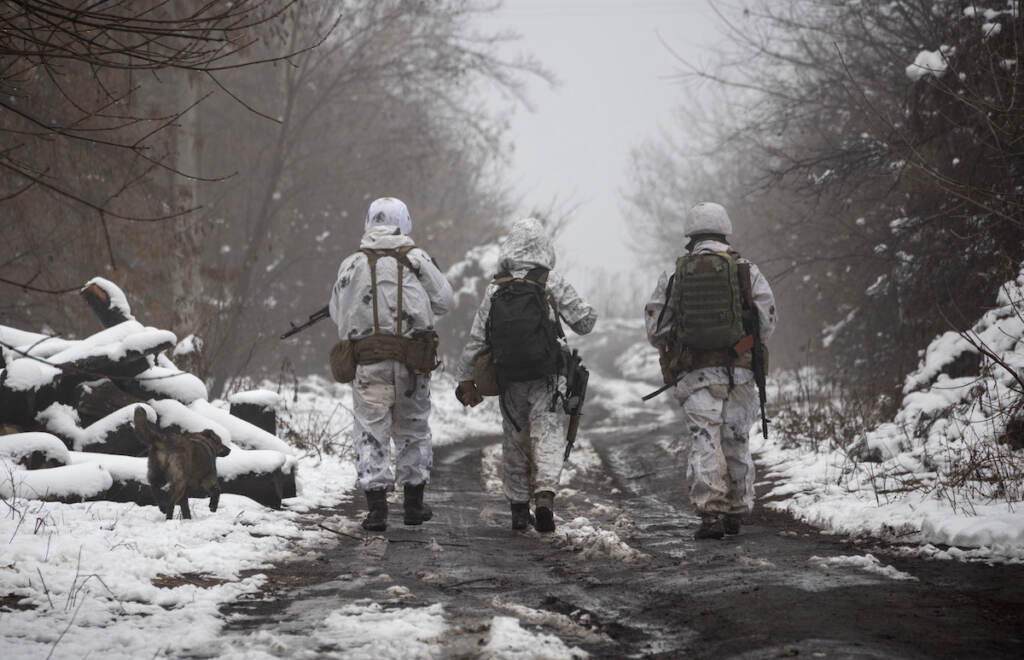 Germany Russia FILE - Ukrainian soldiers walks at the line of separation from pro-Russian rebels near Katerinivka, Donetsk region, Ukraine, Tuesday, Dec 7, 2021. (AP Photo/Andriy Dubchak)