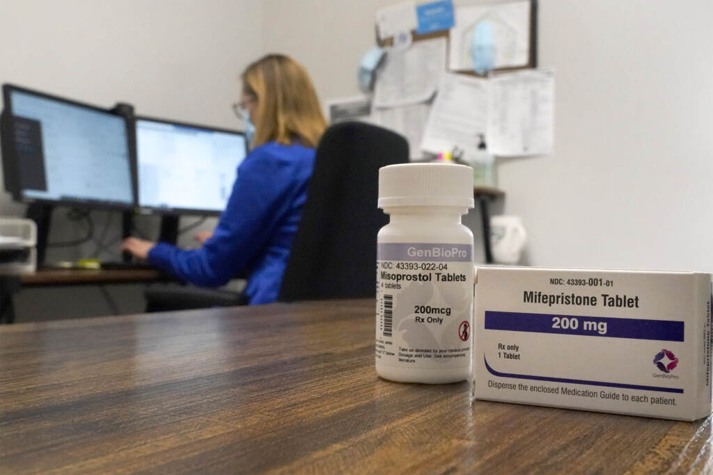 Self Managed Abortions A nurse practitioner works in an office at a Planned Parenthood clinic as containers of the medication used to end an early pregnancy sits on a table nearby