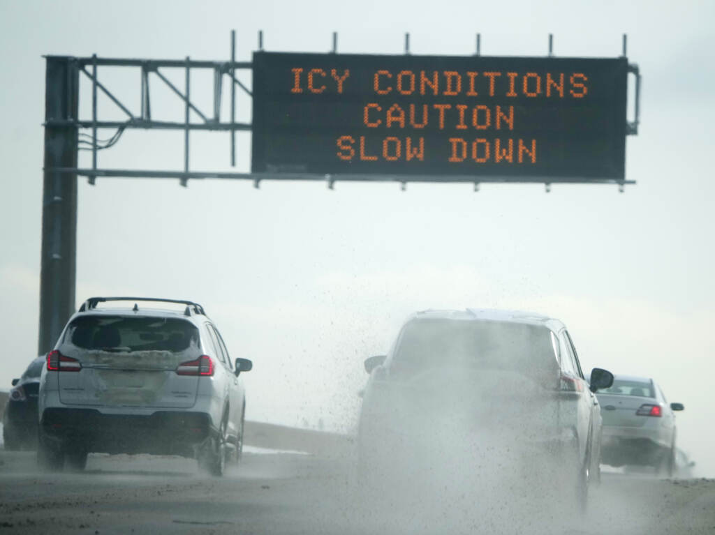 Motorists travel along the southbound lanes of I-25 in Denver after a winter storm dropped up to a foot of snow
