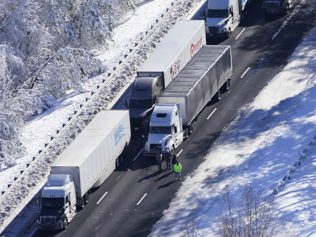 Drivers look down the roadway as cars and trucks are stranded on sections of I-95 in Carmel Church