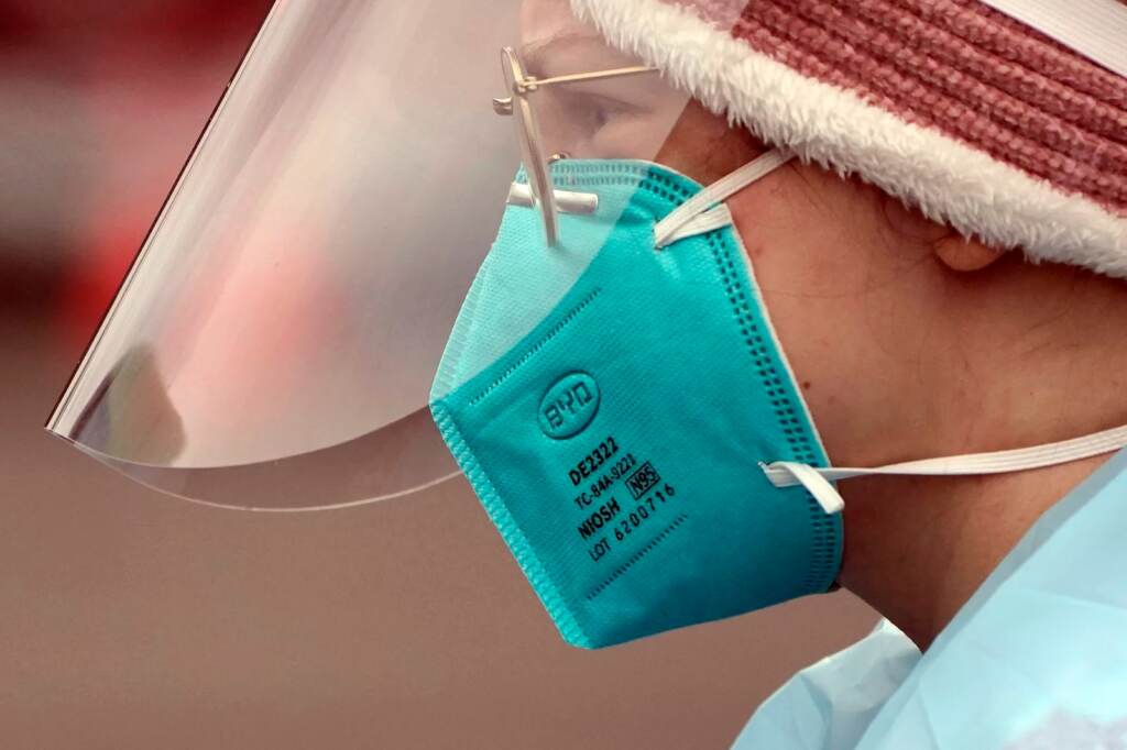 Linsey Jones, a medical assistant working at a drive-up COVID-19 testing clinic, wears an N95 mask on Jan. 4, in Puyallup, Wash. The Biden administration will begin making 400 million N95 masks available for free to Americans starting this week. A closeup of a health care worker wearing an N95 mask
