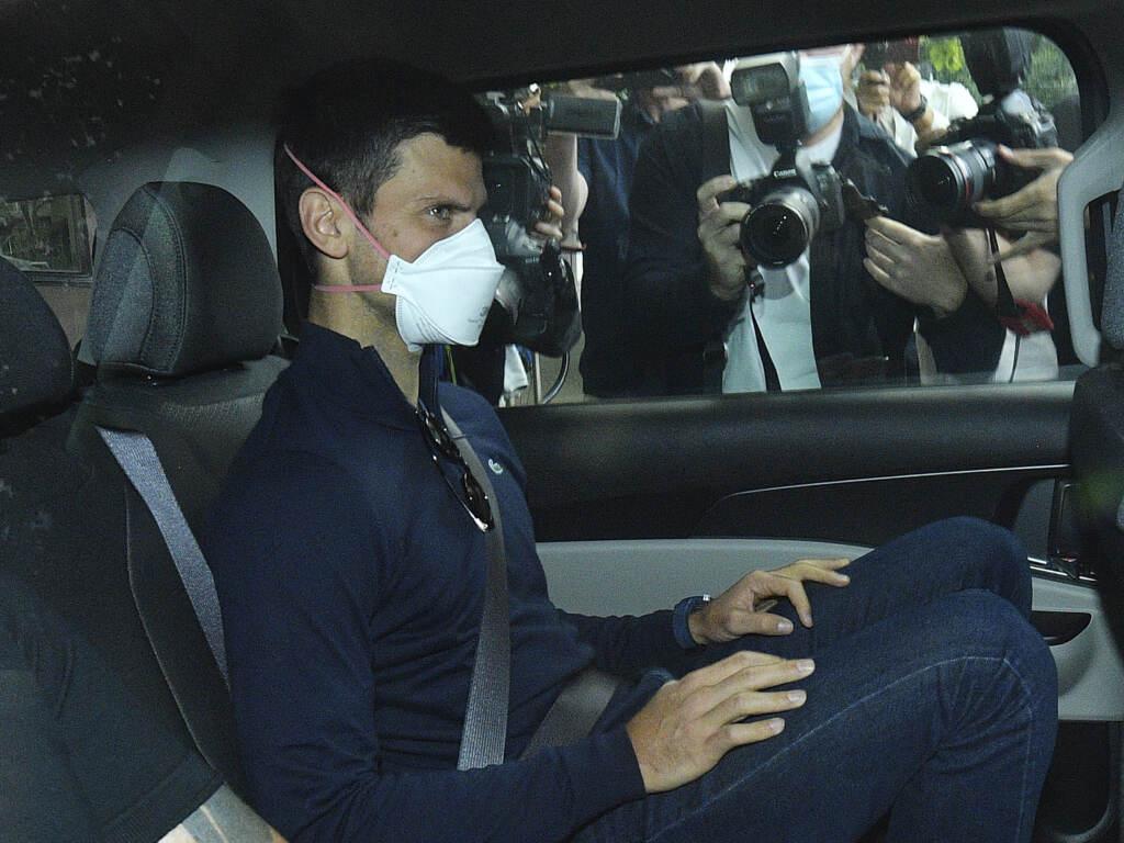 Serbian tennis player Novak Djokovic rides in car as he leaves a government detention facility before attending a court hearing at his lawyers office in Melbourne, Australia, on Jan. 16, 2022. Serbian tennis player Novak Djokovic rides in car as he leaves a government detention facility before attending a court hearing at his lawyers office in Melbourne, Australia, Sunday, Jan. 16, 2022. A federal court hearing has been scheduled for Sunday, a day before the men's No. 1-ranked tennis player and nine-time Australian Open champion was due to begin his title defense at the first Grand Slam tennis tournament of the year. (James Ross/AAP via AP)