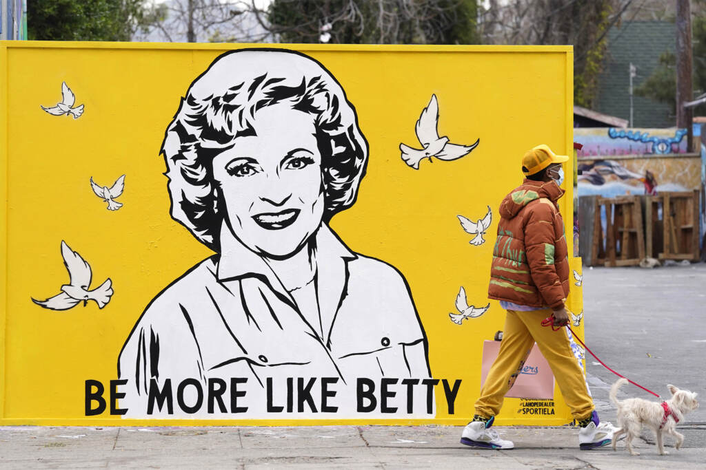 Betty White Mural A man walks a dog past a new mural of the late actress Betty Whit