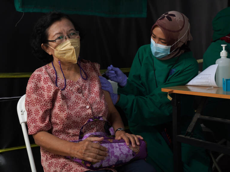An elderly resident receives a dose of the Pfizer-BioNTech COVID-19 vaccine
