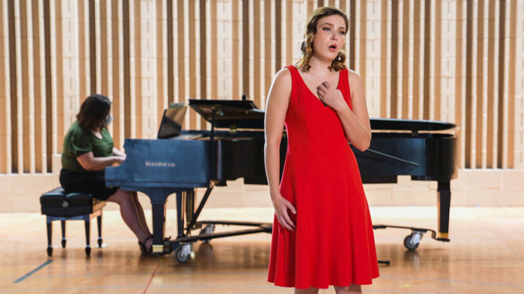 curtis-1612 Ruby Dibble singing in front of someone playing the piano