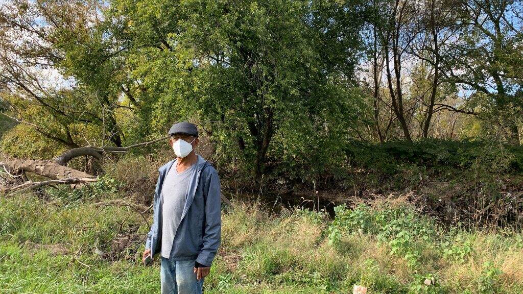 eastwick-flooding-resident-1024×576 Resident Leo Brundage stands in front of the flood-prone creek behind his house (Megan Ruggles)
