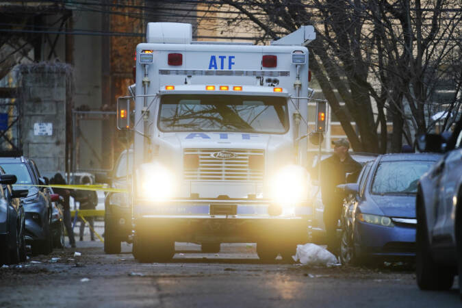 A response vehicle is parked near the scene of a fatal fire